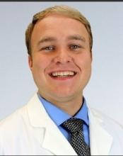 man with blonde hair smiling