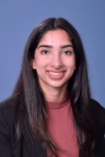 woman in dark pink top with dark hair smiling