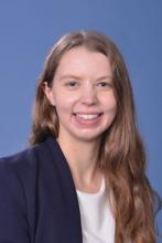 woman with long, dark blonde hair smiling