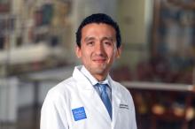 man with short dark hair smiling