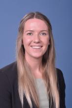woman with long blonde hair in half up hairstyle smiling