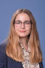 woman with glasses on and long blonde hair smiling