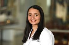woman with medium length dark hair, smiling
