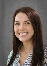 woman with straight, reddish brown hair smiling