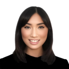 woman with dark, shoulder length hair smiling