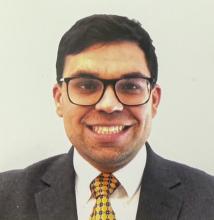 man with glasses and dark hair smiling
