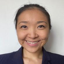 woman with her hair pulled back smiling