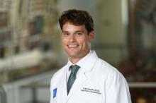 man with short brown hair smiling