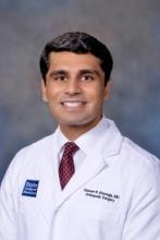 man with short dark hair smiling