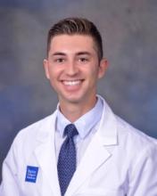 man with short hair smiling