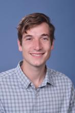 man with short brown hair smiling