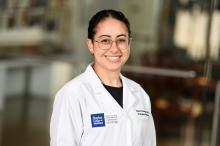 woman with her hair pulled back smiling