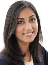 woman with dark, shoulder length hair smiling