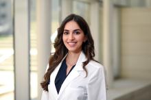 woman with long dark hair smiling