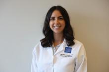 woman with brown, shoulder length hair smiling