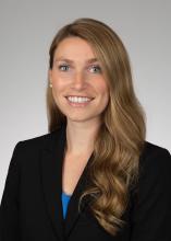 woman with long dark blonde hair smiling