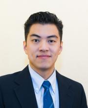 man with dark hair smiling