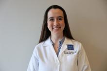 woman with her hair behind her shoulders smiling