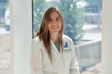woman with long, dark blonde hair smiling