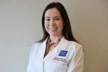 woan with long brown hair smiling