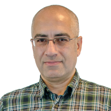 man smiling in front of grey background