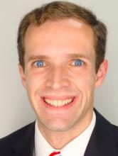 man with blonde hair and blue eyes smiling