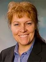 woman smiling in front of grey background