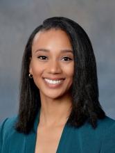 woman with straight, shoulder-length dark hair smiling