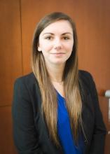 woman with light brown hair smiling lightly