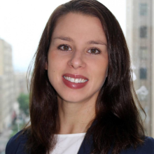 woman smiling in front of grey background