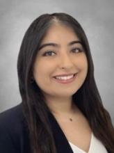 woman with dark, straight hair smiling