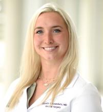 woman with long, platinum blonde hair smiling