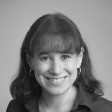 woman smiling in front of grey background