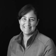 woman smiling in front of grey background
