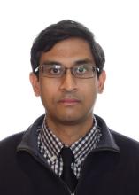 man with glasses on and dark hair