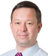 Man smiling in front of white background