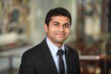 male with dark hair, wearing black suit jackets and dark tie