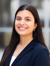 woman with long, straight dark hair smiling