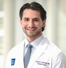 man with dark brown hair smiling