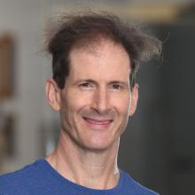 Man smiling in front of white background