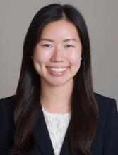 woman with dark, long straight hair smiling