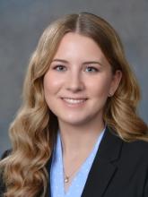 woman with long, curled blonde hair smiling