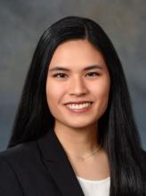 woman with side-parted, dark straight hair smiling