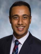 man with very short dark hair smiling