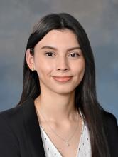 woman with long, very dark hair smiling lightly