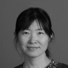 woman smiling in front of grey background