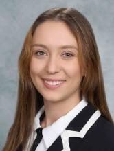 woman with long, dark blonde hair smiling