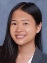 woman with part of her hair behind her ear smiling