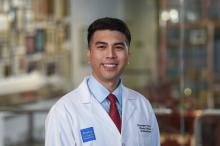 man with short dark hair smiling