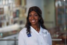 woman with hair that is curled, smiling